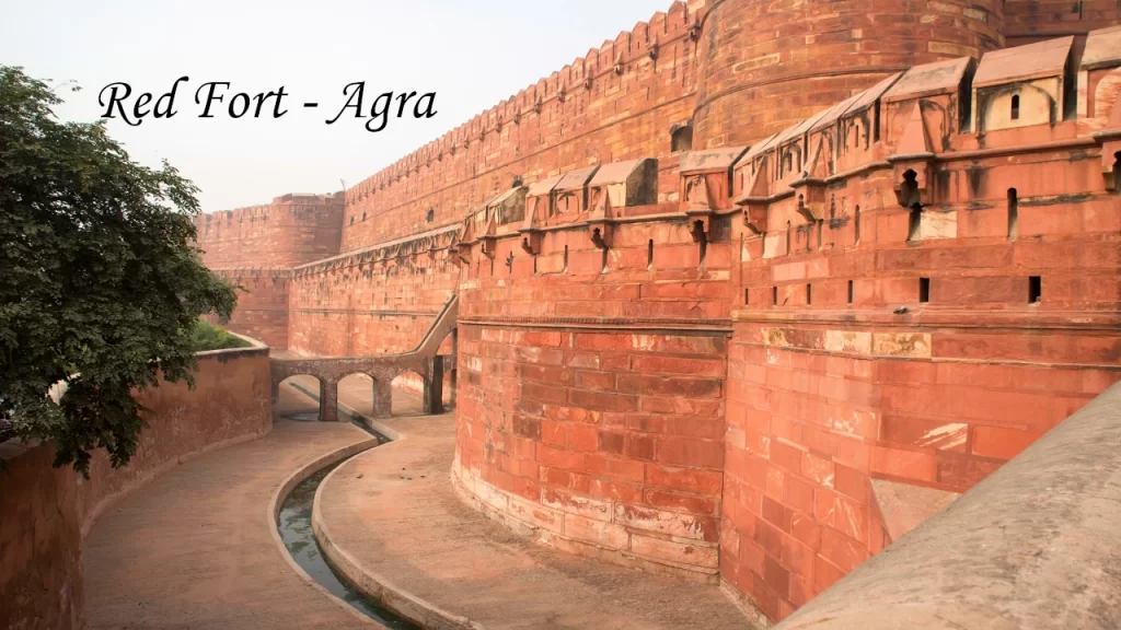 The massive red sandstone walls and moat of Agra Fort, a UNESCO World Heritage site and one of the grandest forts and palaces in India