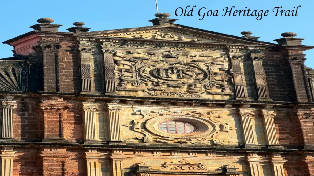 Ornate baroque facade of the Basilica of Bom Jesus in Old Goa with the IHS monogram carved in stone — a UNESCO World Heritage Site to visit on a Goa with Family trip