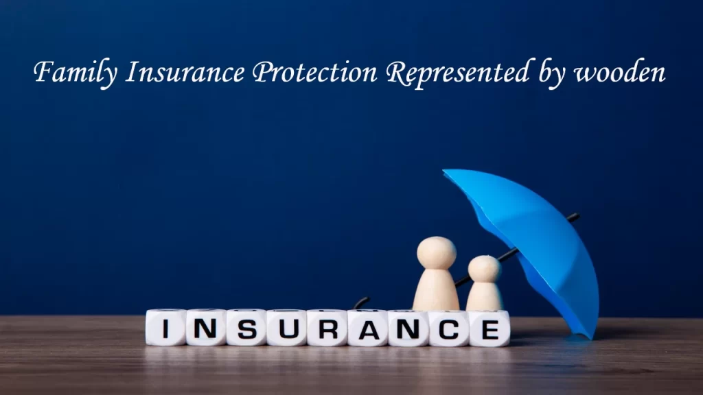 Wooden figurines of a family sheltered under a blue umbrella beside letter blocks spelling INSURANCE – symbolising family travel insurance protection