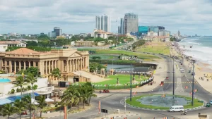 An aerial view of Galle Face Green and the old parliament building in Colombo, Sri Lanka, showing the bustling coastline where visitors can base their kayaking and water sports trips.