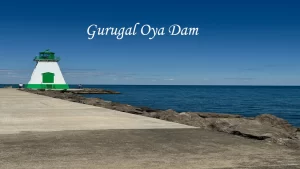 A white and green lighthouse on a stone pier next to the deep blue sea, on the scenic route toward Sri Lanka's hill stations.
