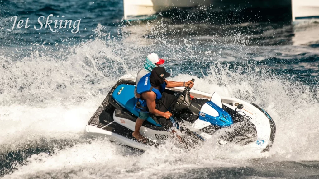 Two people riding a fast jet ski and cutting through ocean waves, showcasing thrilling water sports in Bentota.