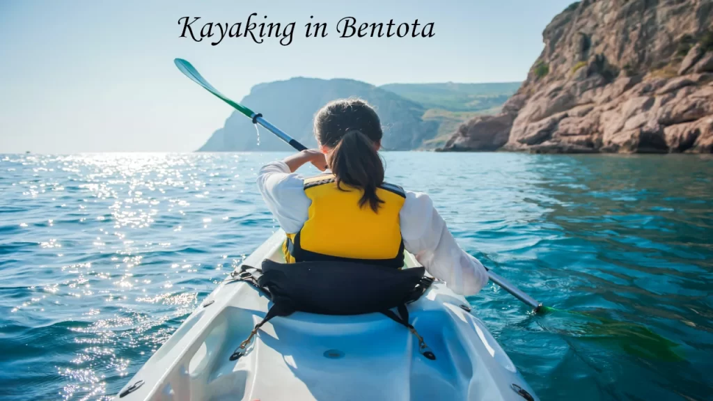 Three excited young people wearing life jackets enjoying a thrilling towed sofa ride on the water, highlighting fun group water sports in Bentota.