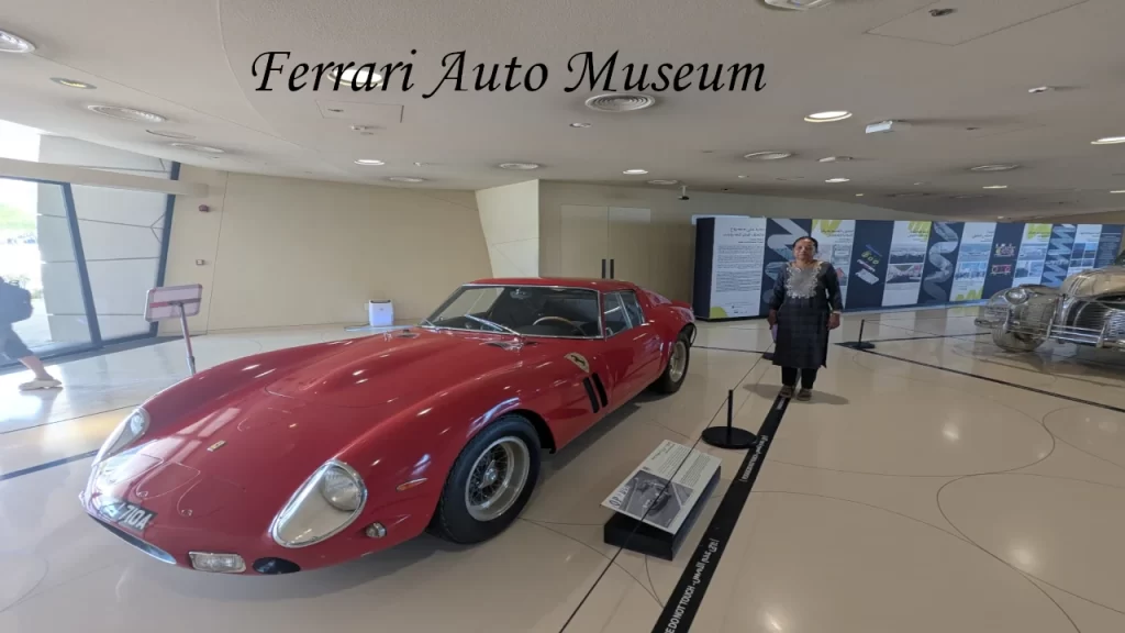 A pristine line of luxury red Ferrari sports cars and classic vintage automobiles displayed inside the Letbelah private museum, showcasing unique places to visit in Doha.