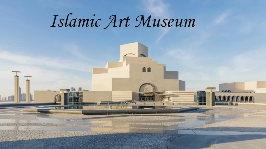 The iconic geometric limestone architecture of the Museum of Islamic Art towering under a bright blue sky, making it one of the top architectural places to visit in Doha.