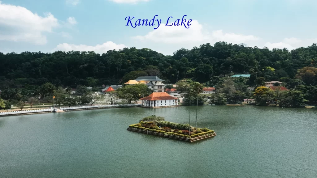 An aerial view of Kandy Lake and the Temple of the Sacred Tooth Relic surrounded by lush green hills, highlighting popular hill stations in Sri Lanka.