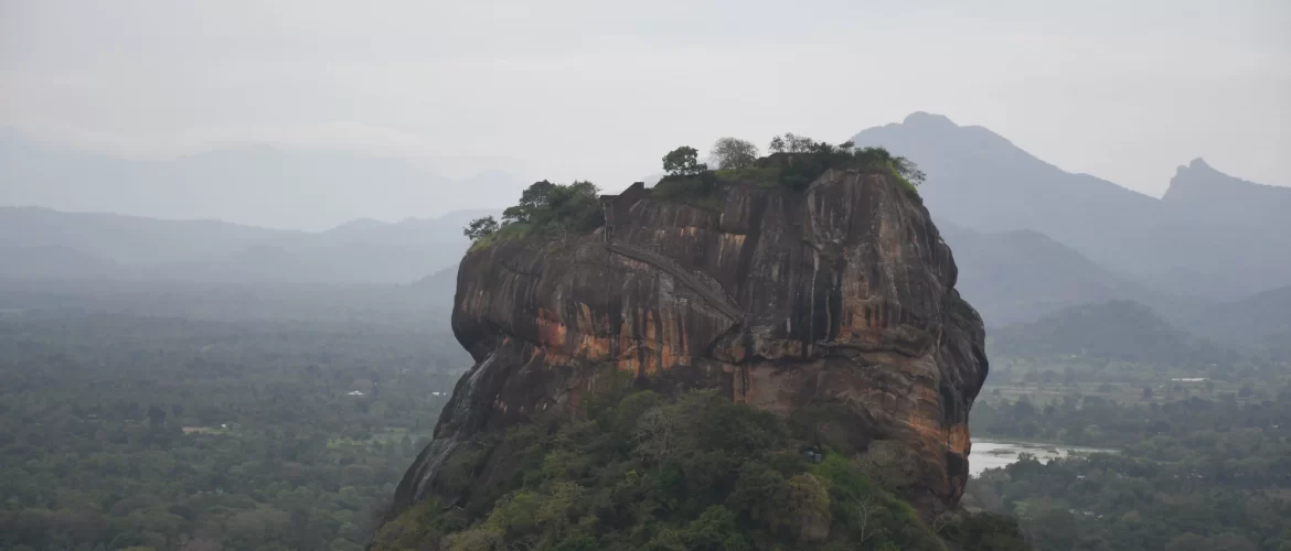 Sigiriya Lion Rock fortress rising above jungle canopy, a UNESCO Heritage Sites in Sri Lanka built by King Kashyapa in the 5th century