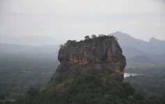 Sigiriya Lion Rock fortress rising above jungle canopy, a UNESCO Heritage Sites in Sri Lanka built by King Kashyapa in the 5th century
