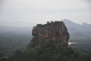Sigiriya Lion Rock fortress rising above jungle canopy, a UNESCO Heritage Sites in Sri Lanka built by King Kashyapa in the 5th century