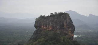 Sigiriya Lion Rock fortress rising above jungle canopy, a UNESCO Heritage Sites in Sri Lanka built by King Kashyapa in the 5th century