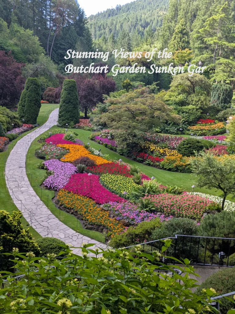 A winding stone path alongside vibrant, multi-colored flower beds in the Sunken Garden at Butchart Garden, Victoria.