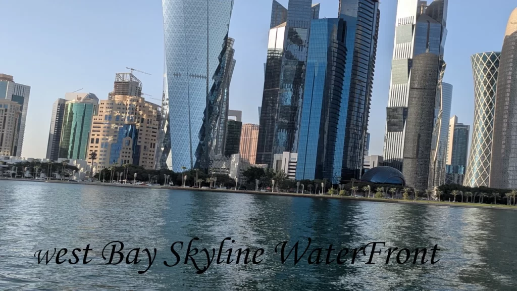 The towering architectural skyscrapers of West Bay reflecting in the clear blue gulf waters during a bright day, a staple sight when researching places to visit in Doha.