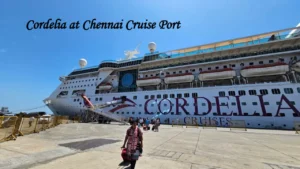 Passengers boarding a luxury Cordelia Cruises liner at the Chennai Port Cruise terminal under a clear blue sky. Cordelia Empress cruise ship docked at Chennai Port at night