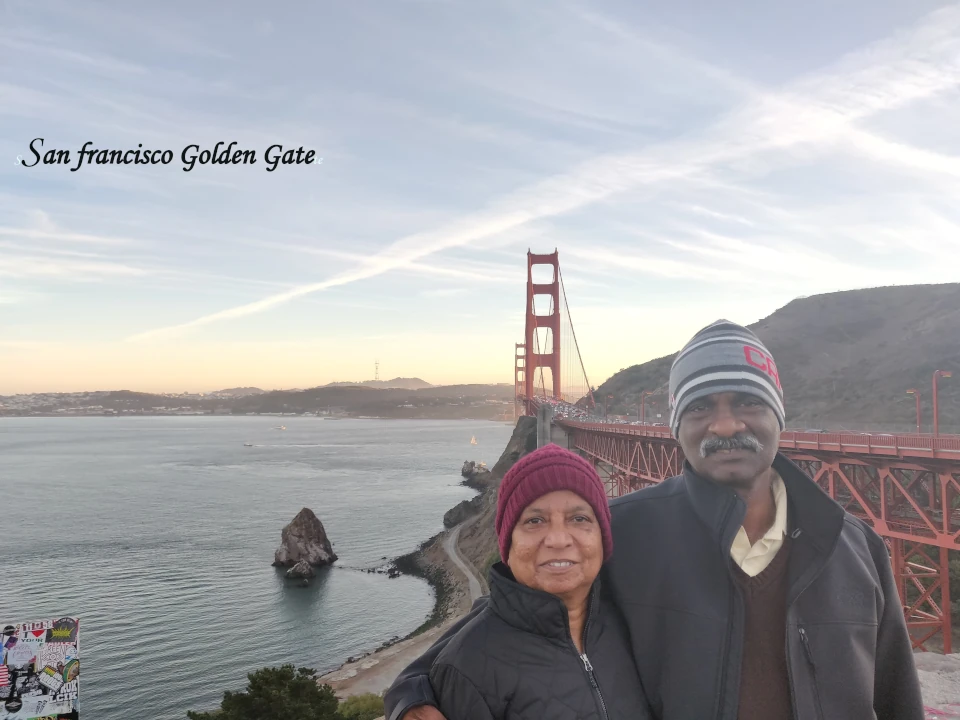 Cities to Visit in America, Visitors posing near the Golden Gate Bridge in San Francisco with panoramic views of the bay, coastline, and iconic red suspension bridge