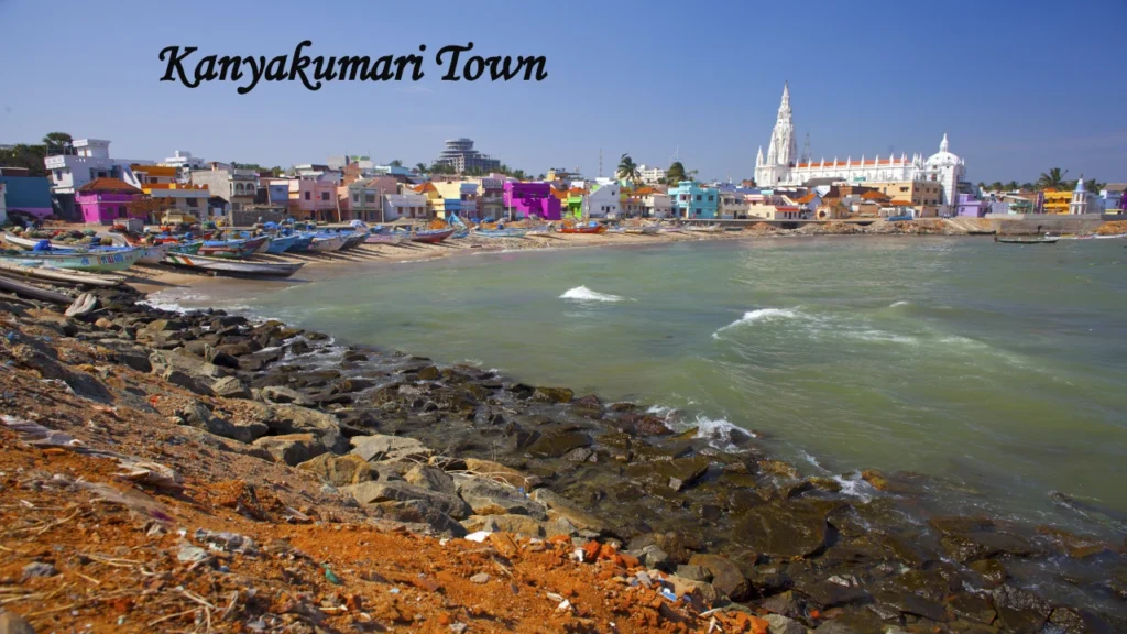 Kanyakumari Town coastal view with fishing boats, colorful houses, and church by the sea, a popular destination to Visit in TamilNadu.