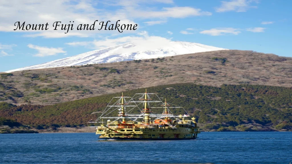 Lake Ashi pirate cruise boat sailing on blue waters with snow capped Mount Fuji in the background during a 7 days tour in Japan.