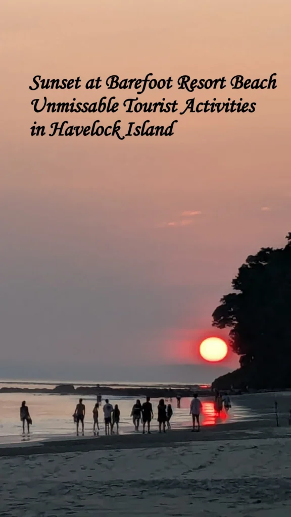 Travelers watching a dramatic red sunset on the beach near Barefoot Resort, capturing one of the ultimate evening tourist activities in Havelock Island.