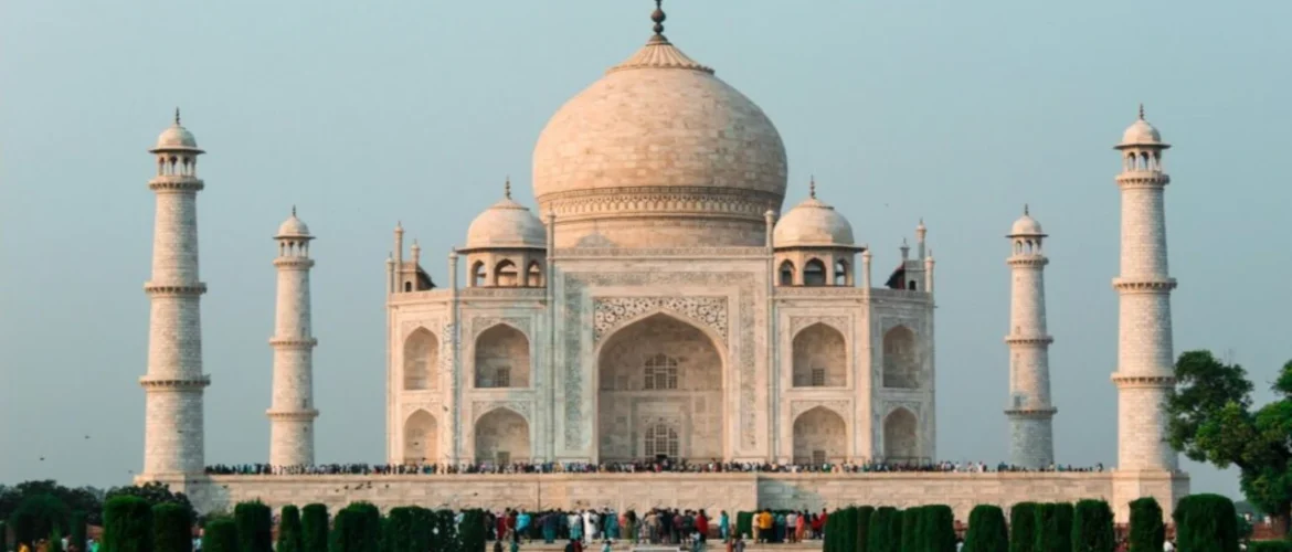Travel to the iconic Taj Mahal in India, featuring white marble architecture, reflecting pools and gardens, a world famous landmark.