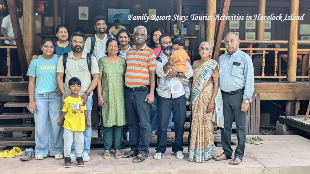 A large multi-generational family posing together for a barefoot resort group photo while enjoying various tourist activities in Havelock Island.