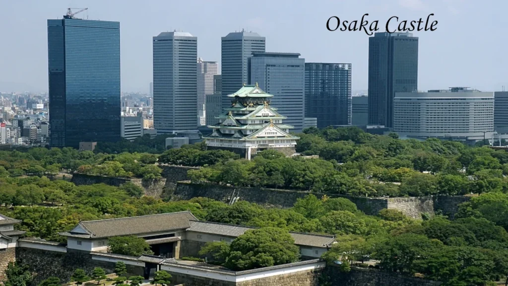 Japan Osaka Castle surrounded by lush gardens and a modern skyline, featured in a Japan 7 Day Itinerary for unforgettable sightseeing.