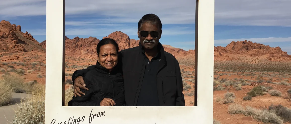Couple posing in front of red sandstone formations at Valley of Fire State Park in Nevada