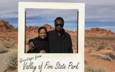 Couple posing in front of red sandstone formations at Valley of Fire State Park in Nevada