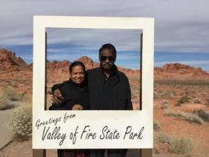 Couple posing in front of red sandstone formations at Valley of Fire State Park in Nevada