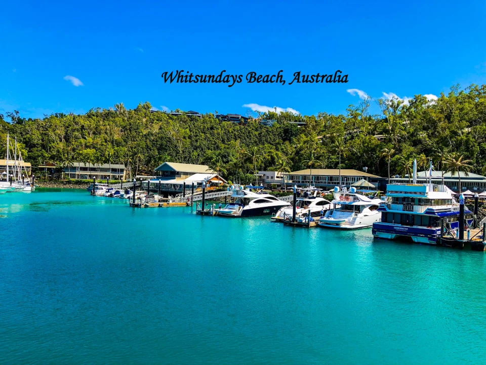 Whitsundays Beach Australia with turquoise water, boats and tropical coastline